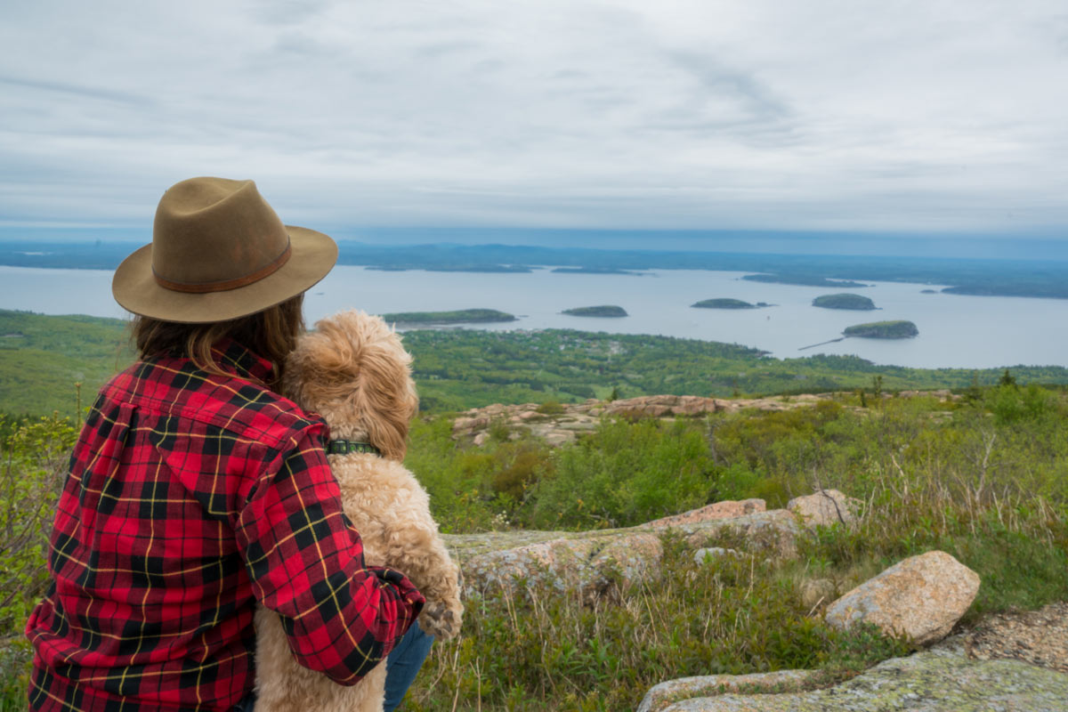 woman hiker, dog, Cadillac Mountain view of the Atlantic Ocean